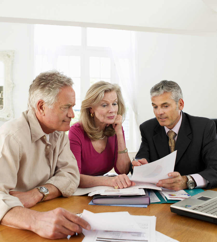 Financial advisor explaining to clients the previous year's results and associated fees.