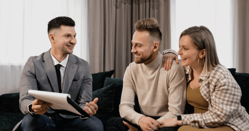 An insurance agent helping his clients understand the policy definitions in their home insurance policy